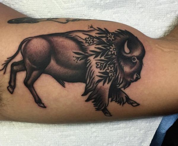 Büffel mit Blumen Tattoo Design am Oberarm