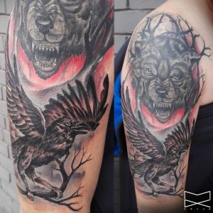 Wolf und Rabe Tattoo am Oberarm