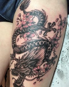 Japanischer Drachen Tattoo mit Blumen am Oberschenkel für Frauen